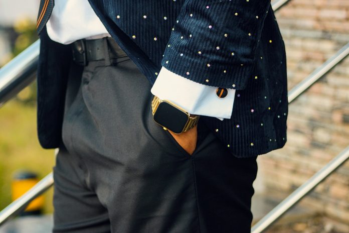 A man in a suit with hand in pocket.